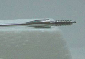Close up of finely machined surgical needle.